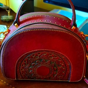 A burgundy purse, 2 zipper openings, used once.